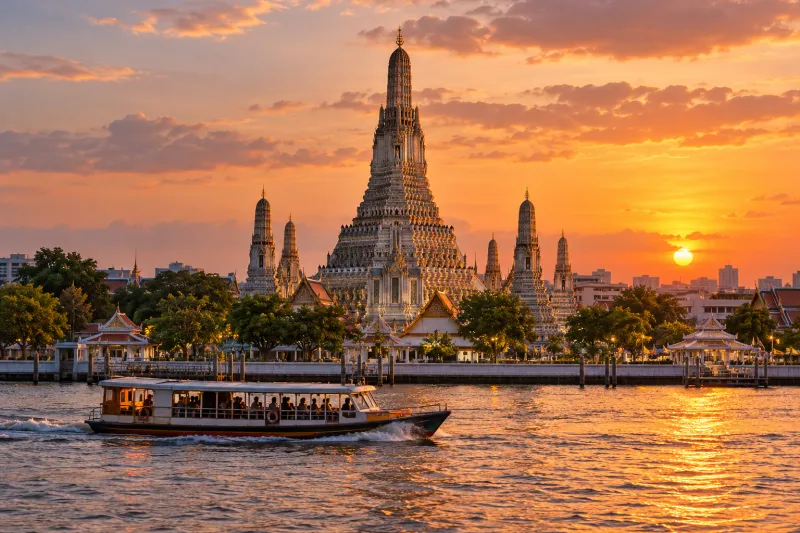 Wat Arun beside Chao Phraya river at sunset